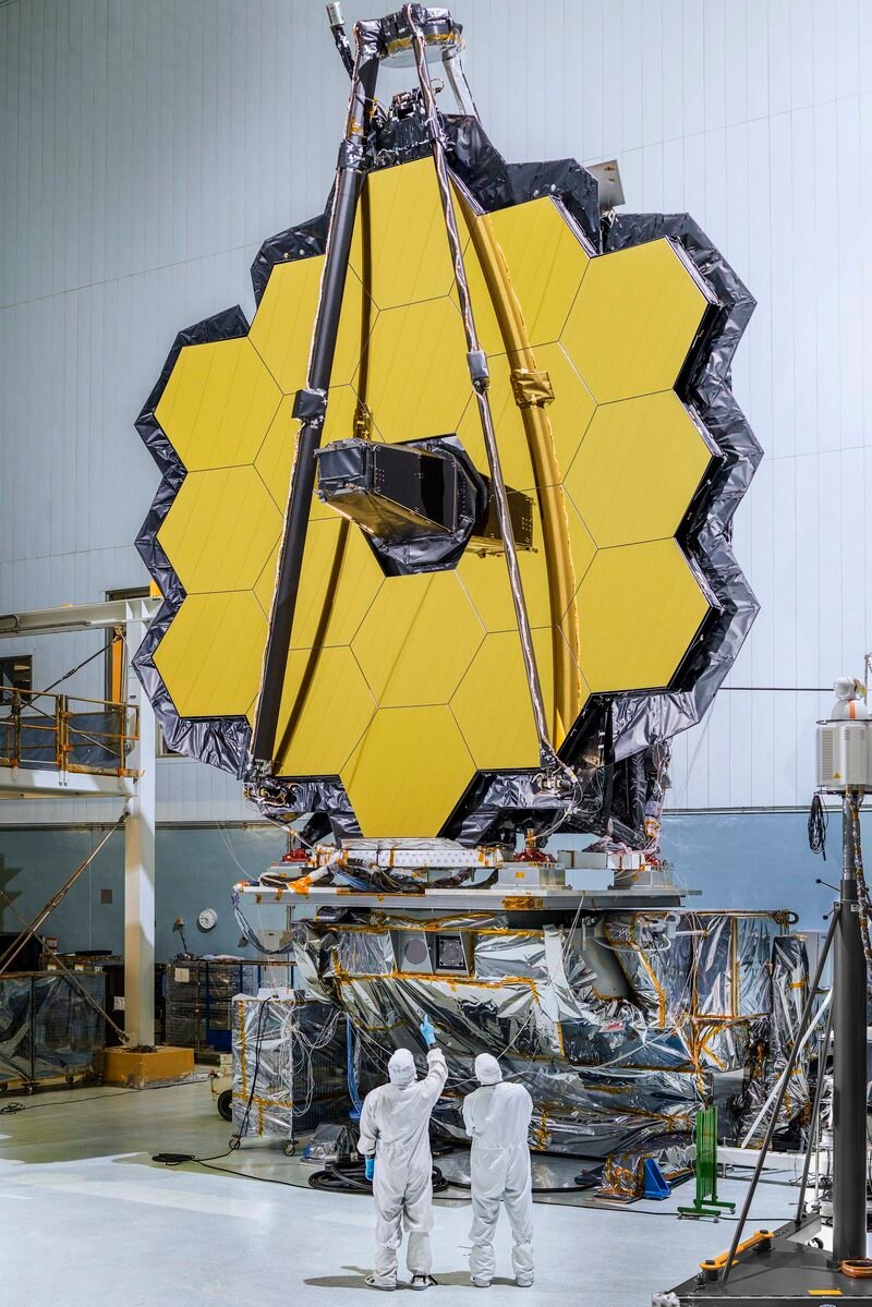 James Webb Space Telescope mirror assembly in a clean room, with engineers below it
